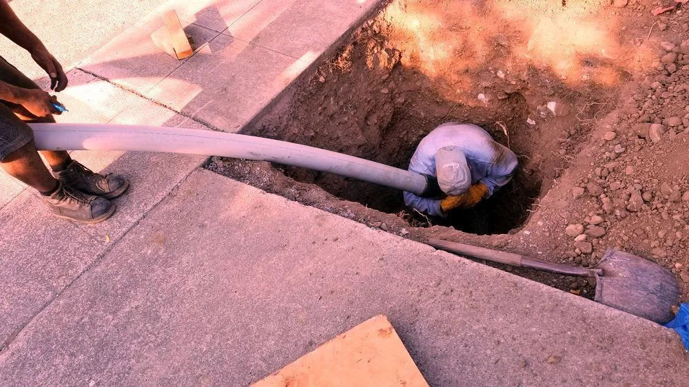 A new pipe being guided into the ground.